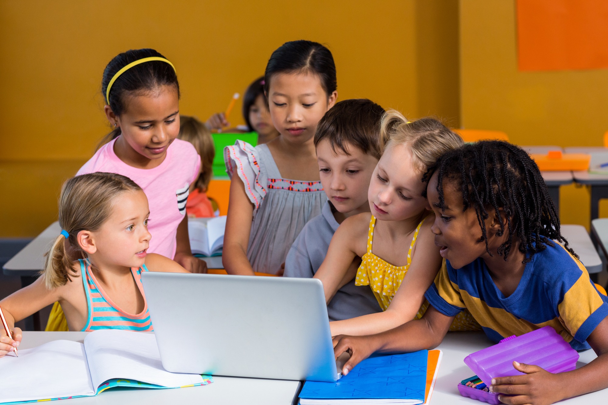 Children using laptop in classroom